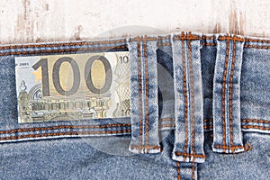 Currencies euro in front blue jeans pocket. Cash payment for shopping concept