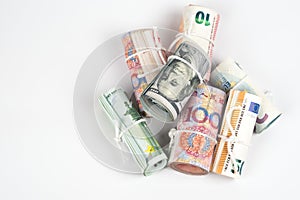 Currencies and money exchange trading concepts. The rolls of different currencies US Dollar, Euro and Chinese yuan banknotes