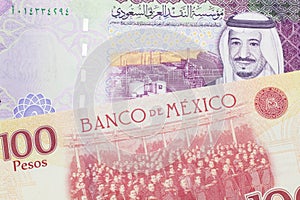 Currency from Mexico close up in macro with currency from Saudi Arabia