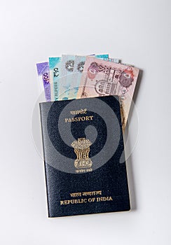 Currency notes UAE and India placed in the Indian passport booklet on white background.