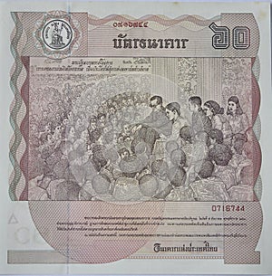 A bank note from Thailand depicting a picture of the late King, value 60 Thai Baht.