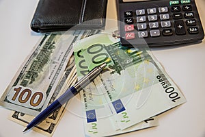 Currency in the wallet and on the table