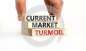 Current market turmoil symbol. Concept words Current market turmoil on wooden blocks on a beautiful white table white background.