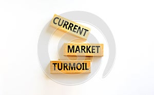 Current market turmoil symbol. Concept words Current market turmoil on wooden blocks on a beautiful white table white background.