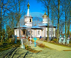 .Wooden Church in the spring with burial crosses