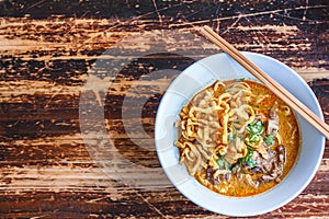 Curried noodle soup Khao soi with beef and spicy coconut milk.