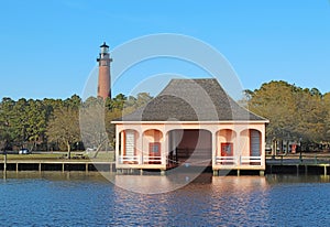 The Currituck Beach Lighthouse and pink boathouse near Corolla, North Carolina