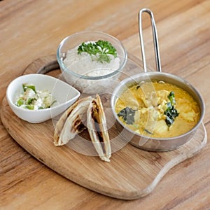 Curry Dish with Paratha serve on wooden tray