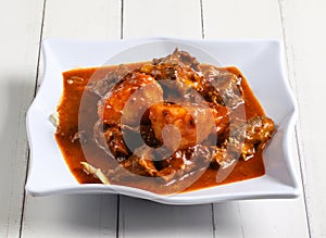 curry lamb ribs with potato served in dish isolated on table top view of singapore food