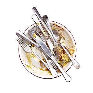 Curry Left overs in a bowl with knives, spoons and Forks