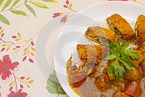 Curry pork chop rice on a european-style pastoral dinner cloth