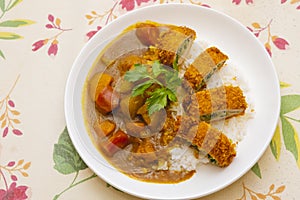 Curry pork chop rice on a european-style pastoral dinner cloth