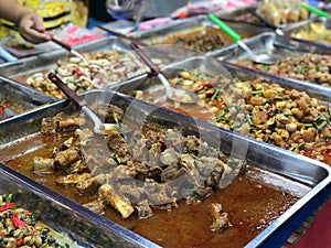 Curry and pork in thai street food market, Thailand.