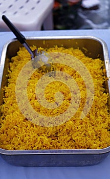 Curry powder fried rice cooked in Indian style in metal tray