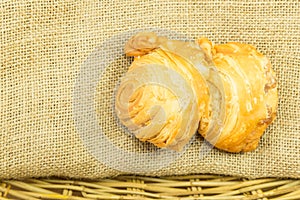 Curry puff on gunny sack texture in wicker basket