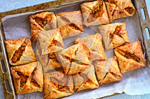 Curry puffs-Vegetarian puff pastry in baking tray photo