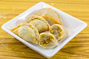 Curry puffs on white plate