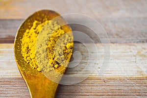 Curry spice in wooden spoon