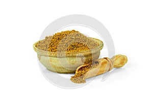 Curry in a wooden cup with a spoon for spices isolated on a white background. Collection of spices and herbs