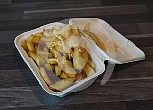 currywurst with fries into a cup. traditional german food to go with dip at corona times photo