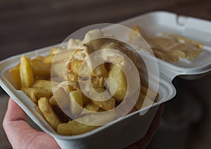 currywurst with fries into a cup. traditional german food to go with dip at corona times photo