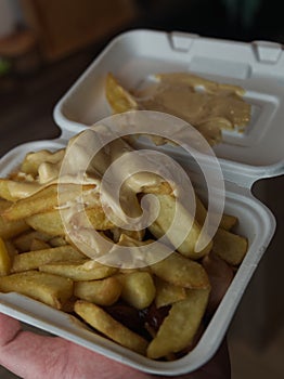 currywurst with fries into a cup. traditional german food to go with dip at corona times photo