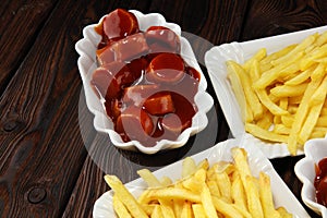 Currywurst with fries. traditional german food with sausages and curry