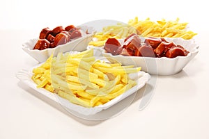 Currywurst with fries. traditional german food with sausages and curry