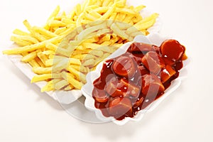 Currywurst with fries. traditional german food with sausages and curry