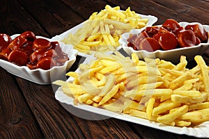 Currywurst with fries. traditional german food with sausages and curry