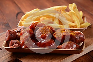 Currywurst Sausages with French fries. Traditional German currywurst  sausages