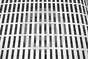 Curtain wall made of toned glass and steel constructions under sky. A fragment of a building. Black and white.