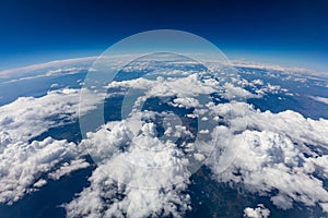 Curvature of planet earth. Aerial shot. Blue sky and clouds