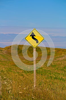 A curve ahead warning sign in the country