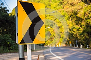 Curve in the forest, Bend street up to the mountain, Traffic warning sign label for show that the road curves