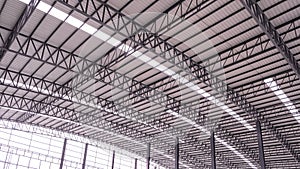 Curve metal roof beam structure with aluminium corrugated steel roof and skylights inside of large industrial factory building