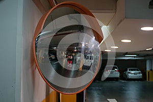 Curve mirror at a basement parking.Traffic mirror safety and security concept. Selective focus