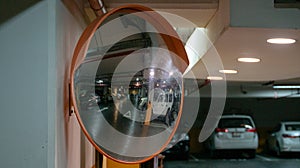 Curve mirror at a basement parking.Traffic mirror safety and security concept. Selective focus