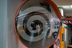 Curve mirror at a basement parking.Traffic mirror safety and security concept. Selective focus