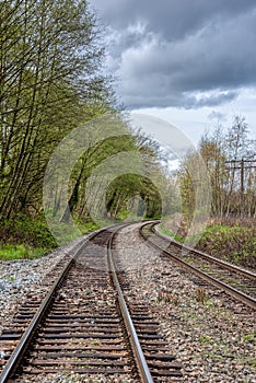 Curve of rail road pathways leading to a city