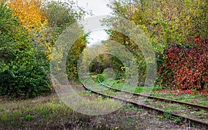 Curve rails. Hopeless post apocalyptic landscape. Cemetery of abandoned broken trains