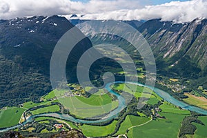 Curve of Rauma river runs through Romsdalen valley in summer season view from  Romsdalseggen trekking trail in West of Norway,