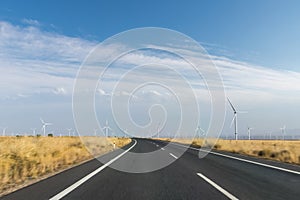 Curve road motion blur through the wind farm