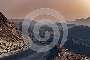 Curve road in the mountain with a sunset background