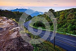 Curve road to the top of misty mountain