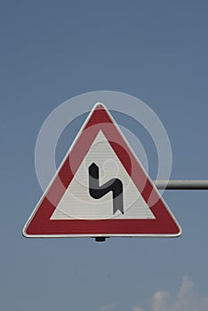 Curve on the road and traffic sign