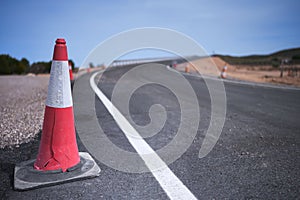 Curve of a road under construction with traffic cones