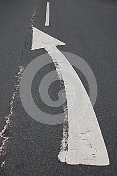 Curved arrow road sign indicating to motorists to get in lane UK