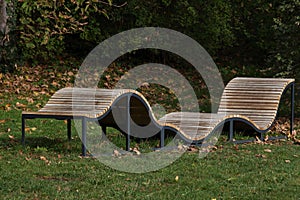 Curved bench of wooden slats in the park