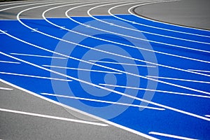 Curved blue and gray running track with textured surface, crisp lines